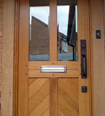 Traditional front door with four panels and chevron detailing